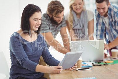 Smiling businesswoman holding tablet