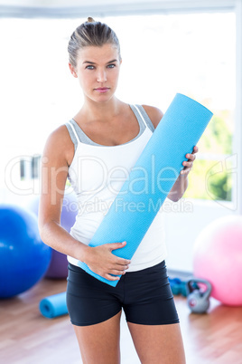 Beautiful woman holding yoga mat Beautiful woman holding yoga mat