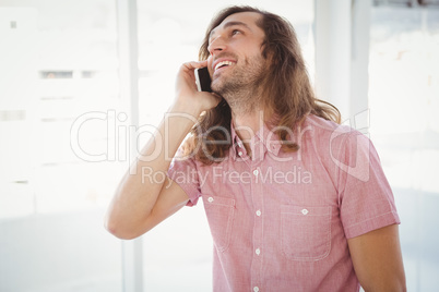 Hipster smiling while using mobile phone
