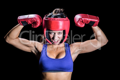 Portrait of angry female boxer flexing muscles
