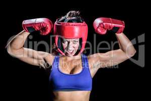 Portrait of angry female boxer flexing muscles