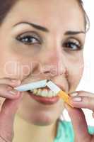 Close-up portrait of happy woman holding cigarette