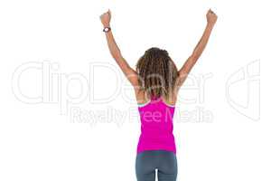 Rear view of young woman cheering with arms raised