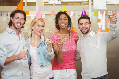Colleagues holding champagne flute in birthday party