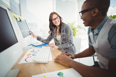 Smiling business people wearing eyeglasses working at computer d