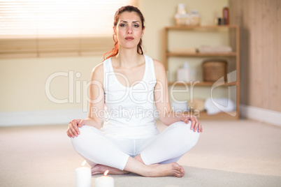 Portrait of woman meditating on floor