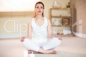 Portrait of woman meditating on floor