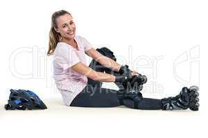 Portrait of cheerful sporty woman wearing inline skates