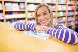 Thoughtful woman leaning on desk