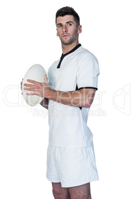 Focused rugby player holding ball