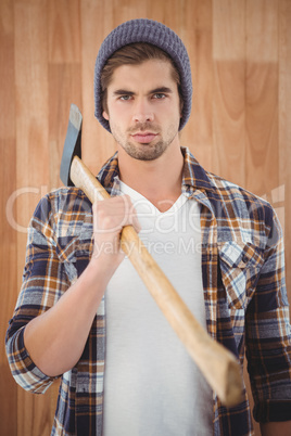 Portrait of hipster holding axe on shoulder