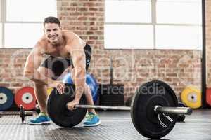 Muscular man set up his barbell weight