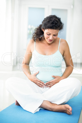 Pregnant woman touching her belly