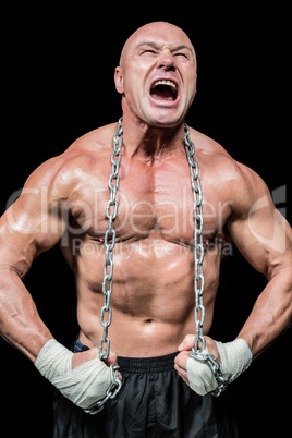 Muscular man shouting while flexing muscle