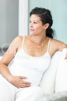 Happy woman sitting on lounge sofa