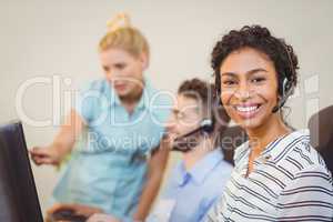 Female employee with coworkers working