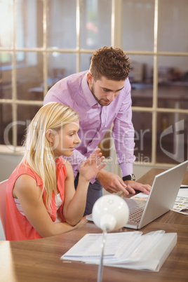 Businessman explaining female colleague