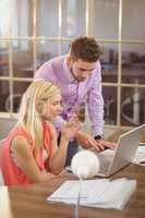 Businessman explaining female colleague