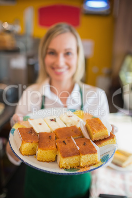 Female worker serving pastries