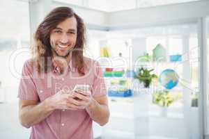Portrait of cheerful hipster using mobile phone