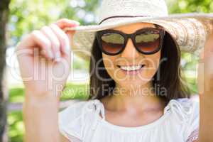 Happy young woman with sunglasses and hat