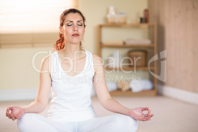 Calm woman in yoga pose with eyes closed