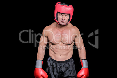 Portrait of shirtless man with boxing headgear and gloves