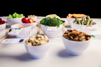 Portion cups and spoons of healthy ingredients