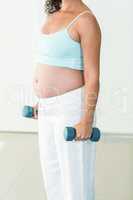 Pregnant woman lifting weights