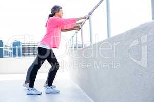 Women leaning on railing while exercising