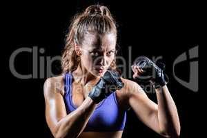 Portrait of female confident boxer with fighting stance