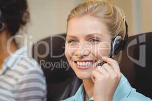 Portrait of smiling businesswoman in call center