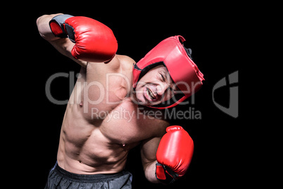 Aggressive boxer against black background