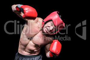 Aggressive boxer against black background