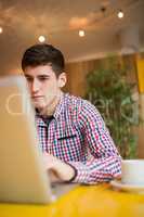 Confident young man using laptop