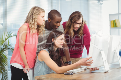 Business team discussing at computer desk