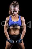 Female fighter flexing muscles