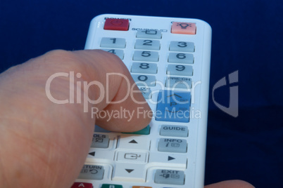 finger presses the button on the remote control, white