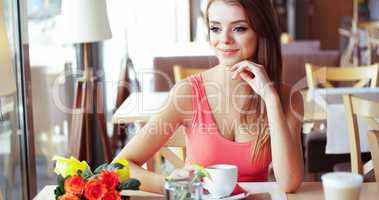Smiling Young Woman in Sunny Cafe