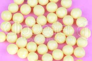 yellow vitamins on pink background
