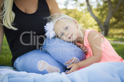 Beautiful Young Girl Resting on Her Mommy's Lap At Park