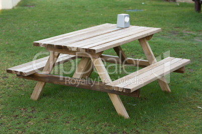 Small wooden picknickplace on a green field photo