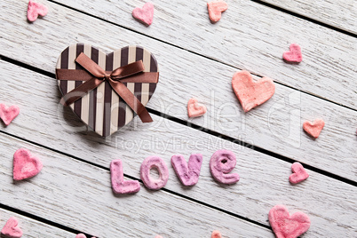 Word Love with heart shaped gift box
