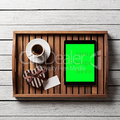 Gift box with blank tag, cup of coffee and tablet