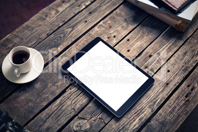Tablet computer on table with cup of coffee