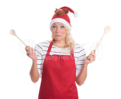 Weihnachtsfrau mit Kochlöffeln schaut skeptisch