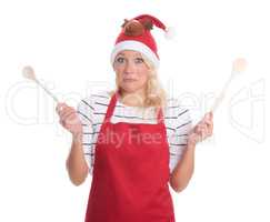 Weihnachtsfrau mit Kochlöffeln schaut skeptisch