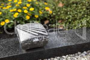 Holy water shell at the grave