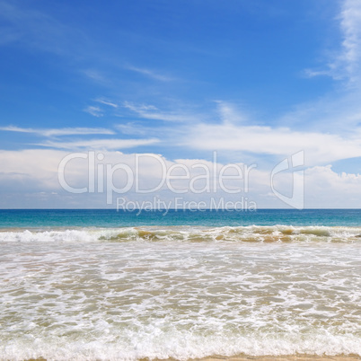 ocean, sandy beach and blue sky