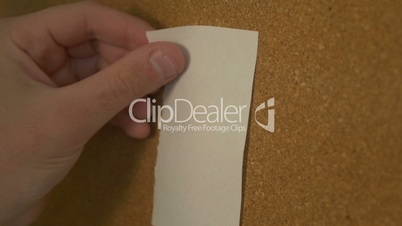 Pinning a paper on cork board